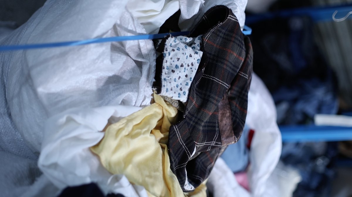 Pile of reclaimed scrap fabrics used as raw material for FabricMERCH